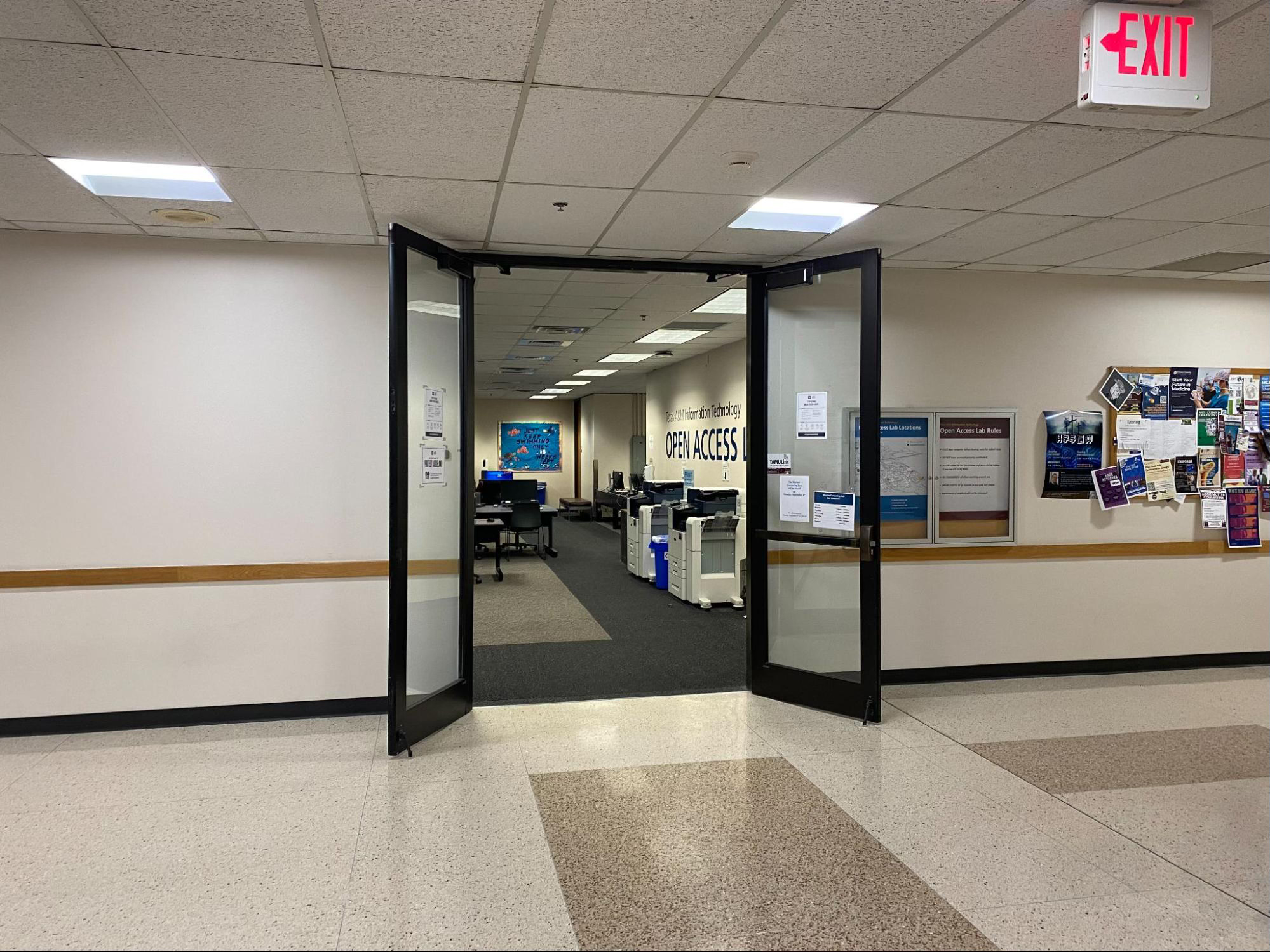 Entrance to an open access computer lab, featuring a view of the space with computers and printing services visible.