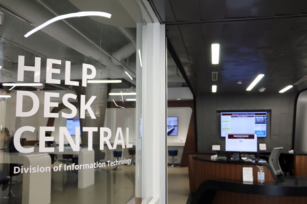 The words 'Help Desk Central' displayed on a curved glass wall inside the space.